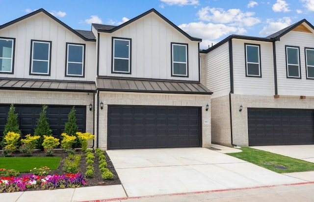 1955 Settlers Glen Dr Unit 5402, Round Rock, TX 78665 - view of front of home featuring a standing seam roof, an attached garage, brick siding, and driveway