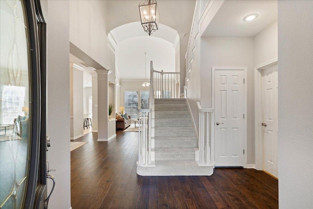 5201 Keene Cv, Austin, TX 78730 - entrance foyer with dark wood-style floors, stairway, a towering ceiling, baseboards, and decorative columns