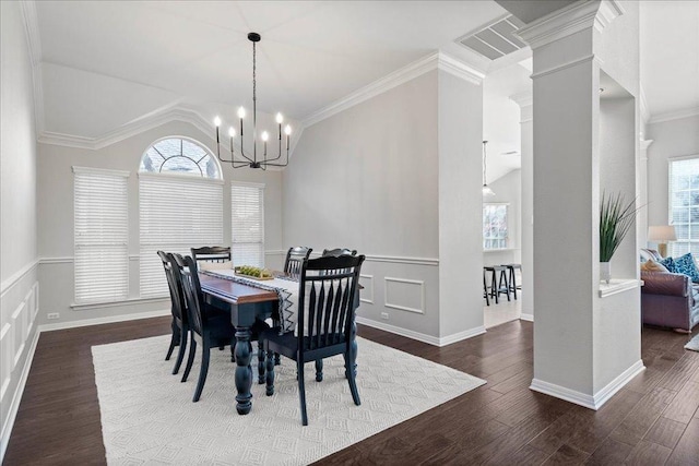 5201 Keene Cv, Austin, TX 78730 - dining area featuring a chandelier, ornamental molding, wood finished floors, lofted ceiling, and ornate columns