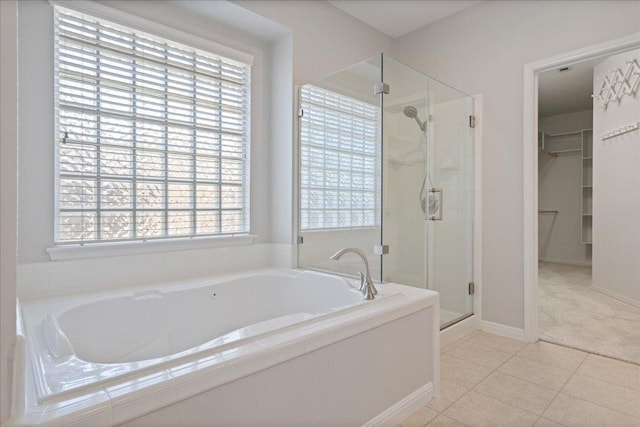 5201 Keene Cv, Austin, TX 78730 - bathroom featuring a shower stall, a bath, a spacious closet, and tile patterned floors
