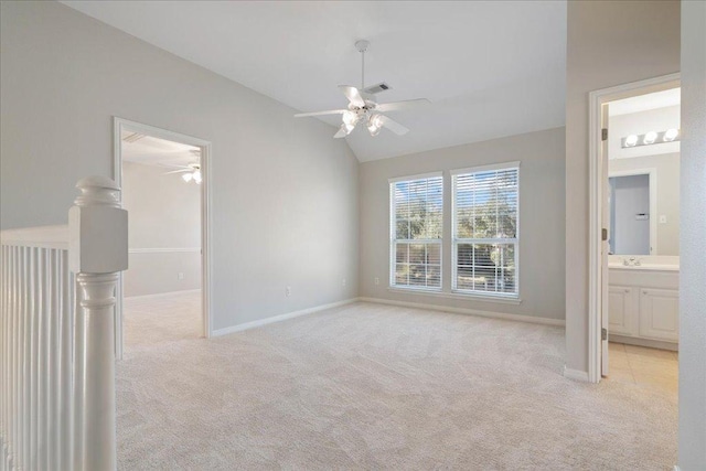 5201 Keene Cv, Austin, TX 78730 - unfurnished bedroom featuring light colored carpet, lofted ceiling, connected bathroom, a spacious closet, and a ceiling fan