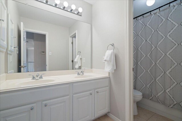 5201 Keene Cv, Austin, TX 78730 - full bathroom featuring toilet, double vanity, and tile patterned floors