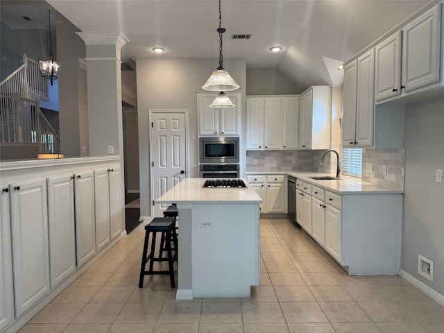 5201 Keene Cv, Austin, TX 78730 - kitchen with appliances with stainless steel finishes, a chandelier, decorative backsplash, light countertops, and light tile patterned floors