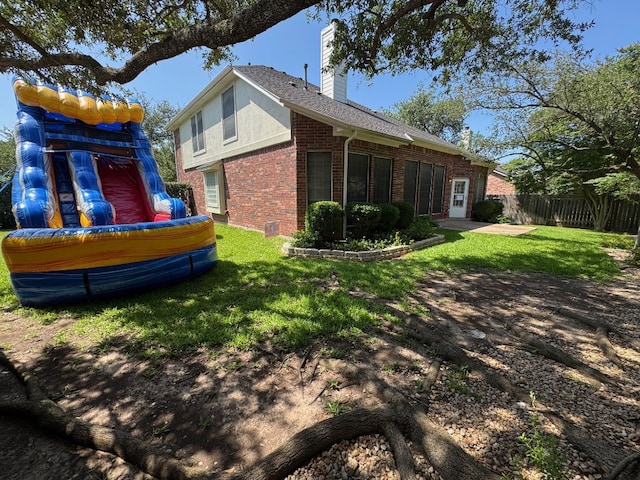 5201 Keene Cv, Austin, TX 78730 - back of house featuring brick siding, a chimney, and a patio