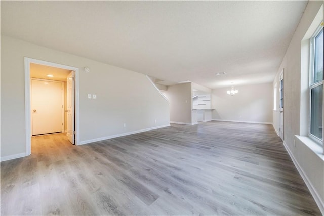 3901 Skipton Dr, Austin, TX 78727 - unfurnished living room with a chandelier and wood finished floors