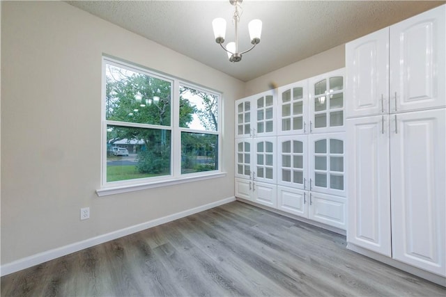 3901 Skipton Dr, Austin, TX 78727 - spare room featuring light wood-type flooring and a chandelier