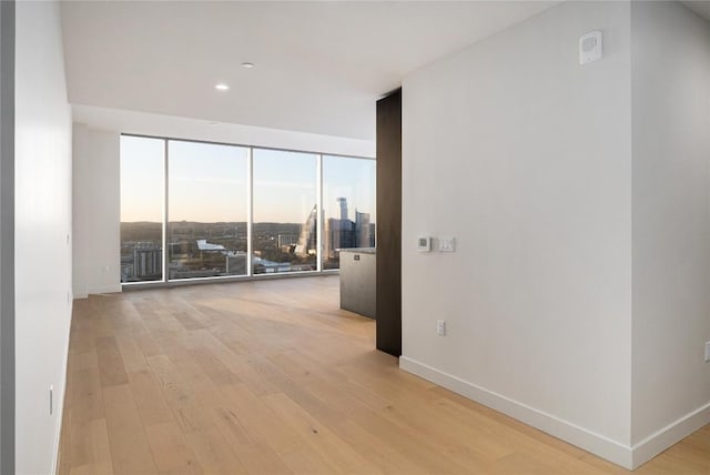44 E Ave Unit 3203, Austin, TX 78701 - unfurnished room featuring expansive windows, light wood finished floors, and a view of city