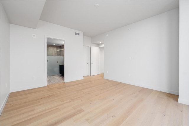 44 E Ave Unit 3203, Austin, TX 78701 - spare room featuring wood finished floors and baseboards