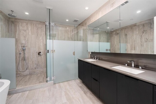 44 E Ave Unit 3203, Austin, TX 78701 - bathroom with a stall shower, double vanity, recessed lighting, and a freestanding bath