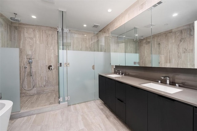 44 E Ave Unit 3203, Austin, TX 78701 - bathroom with a stall shower, double vanity, a freestanding tub, and recessed lighting