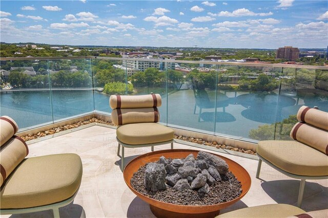 44 E Ave Unit 3203, Austin, TX 78701 - view of patio with an outdoor fire pit, a balcony, and a city view