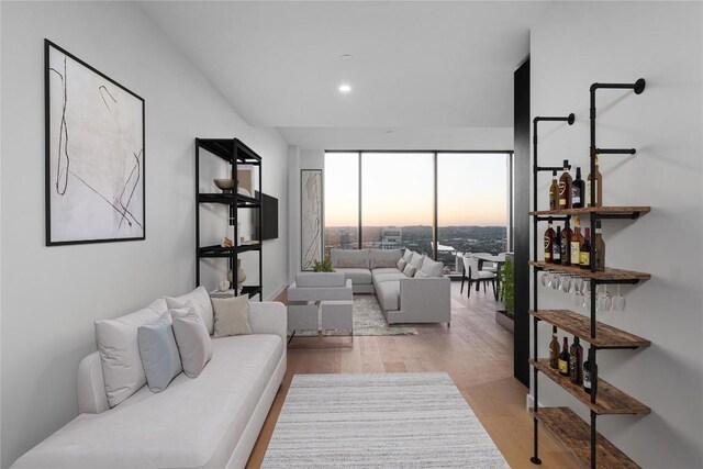 44 E Ave Unit 3203, Austin, TX 78701 - living room with light wood-style floors, a wall of windows, and recessed lighting