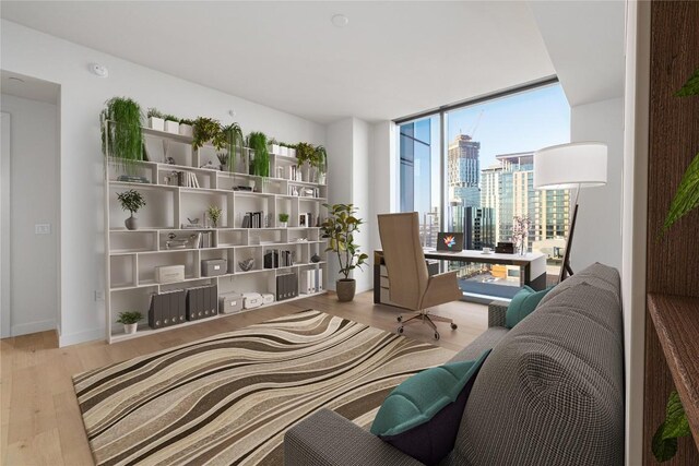 44 E Ave Unit 3203, Austin, TX 78701 - living area featuring wood finished floors, floor to ceiling windows, a view of city, and baseboards