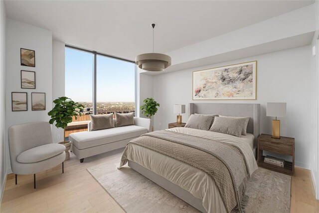 44 E Ave Unit 3203, Austin, TX 78701 - bedroom featuring light wood-style floors and floor to ceiling windows