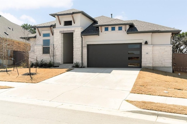 129 Du Bois Ln, Kyle, TX 78640 - view of front facade with stone siding, stucco siding, concrete driveway, and a shingled roof