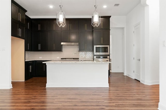 129 Du Bois Ln, Kyle, TX 78640 - kitchen featuring appliances with stainless steel finishes, decorative backsplash, wood finished floors, baseboards, and recessed lighting