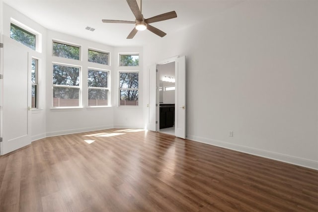 129 Du Bois Ln, Kyle, TX 78640 - unfurnished living room featuring ceiling fan, wood finished floors, and baseboards