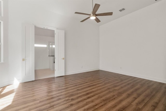 129 Du Bois Ln, Kyle, TX 78640 - spare room with ceiling fan, wood finished floors, and baseboards