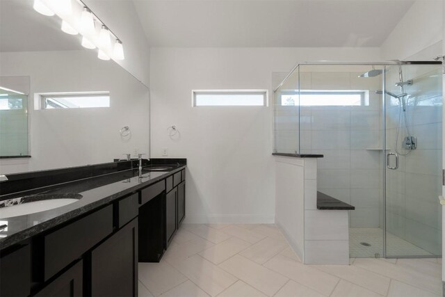 129 Du Bois Ln, Kyle, TX 78640 - full bath featuring double vanity, a stall shower, and baseboards
