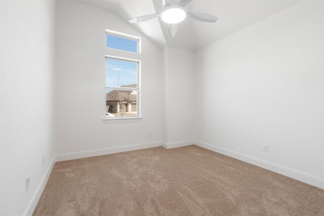 129 Du Bois Ln, Kyle, TX 78640 - spare room featuring light carpet, vaulted ceiling, a ceiling fan, and baseboards