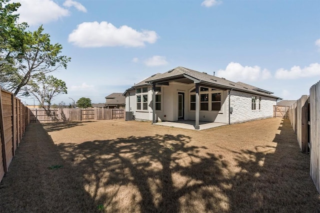 129 Du Bois Ln, Kyle, TX 78640 - rear view of property featuring cooling unit, a patio, a fenced backyard, a shingled roof, and stucco siding