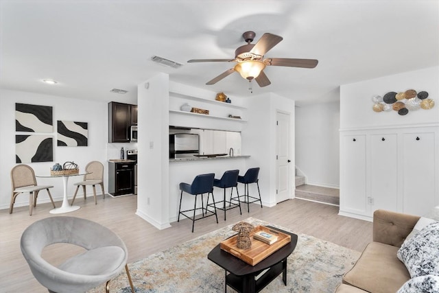 6700 Cooper Ln Unit 30, Austin, TX 78745 - living area featuring ceiling fan, stairs, and light wood-style floors