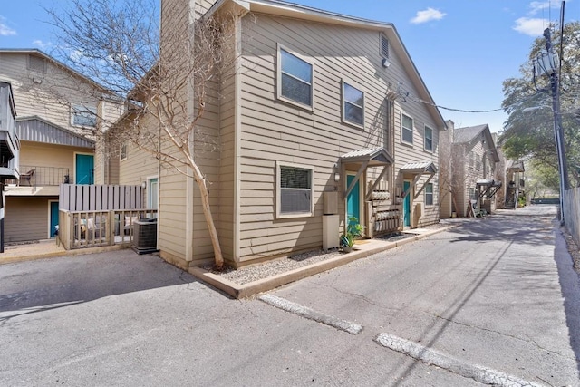 6700 Cooper Ln Unit 30, Austin, TX 78745 - view of property with asphalt driveway and a chimney