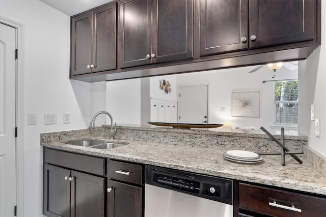 kitchen with a sink, dishwasher, dark brown cabinetry, and light stone countertops