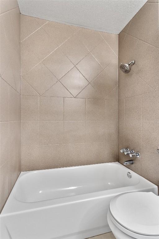 bathroom with shower / bath combination and toilet