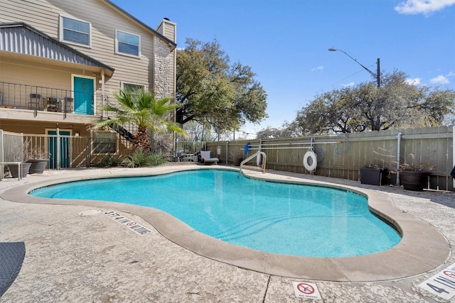 community pool featuring fence