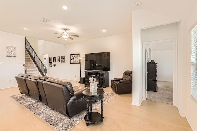 living room featuring light wood-style floors, a ceiling fan, visible vents, recessed lighting, and stairway