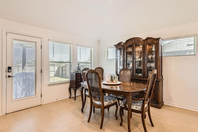 dining area with baseboards and light wood-type flooring