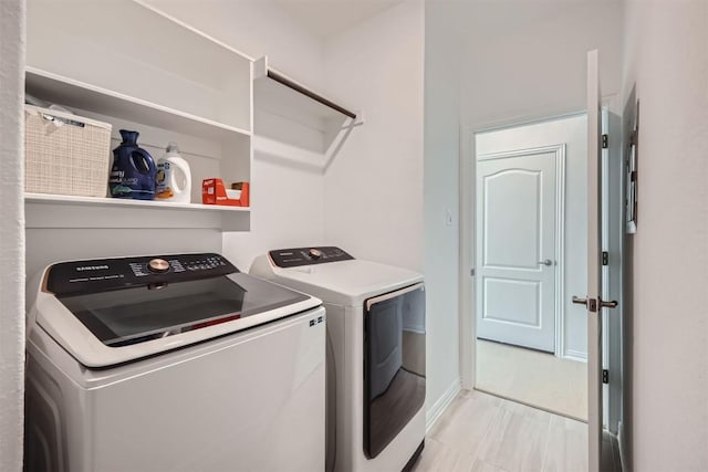 laundry room featuring separate washer and dryer, laundry area, and baseboards
