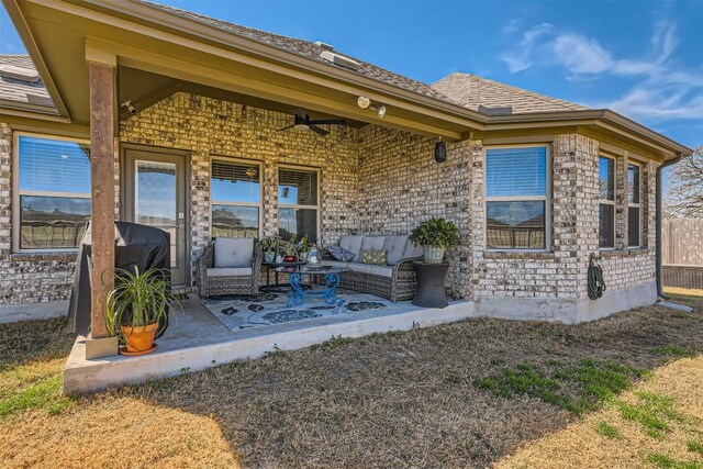 exterior space featuring a grill and an outdoor hangout area