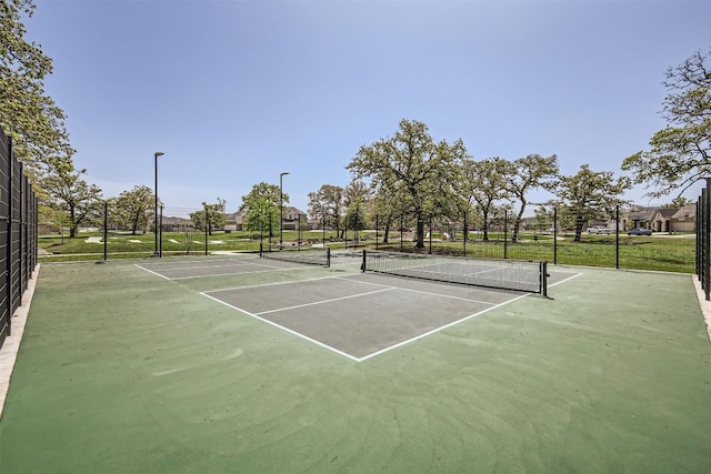 view of sport court featuring fence