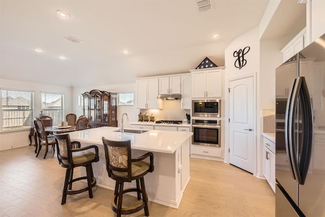 kitchen with a sink, visible vents, light countertops, and appliances with stainless steel finishes