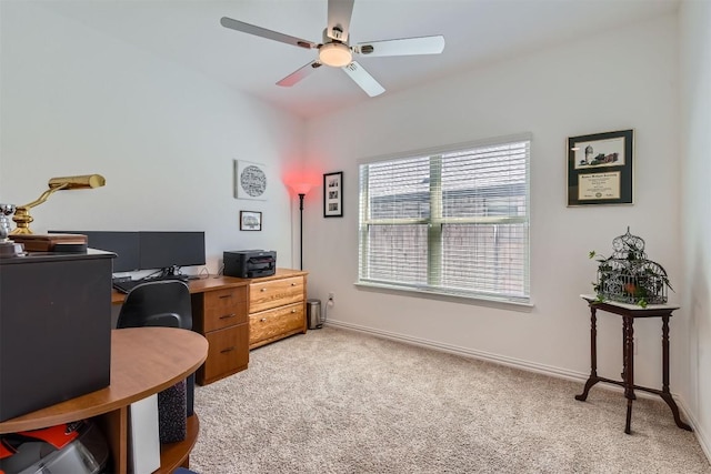 office area with light colored carpet, baseboards, and a ceiling fan