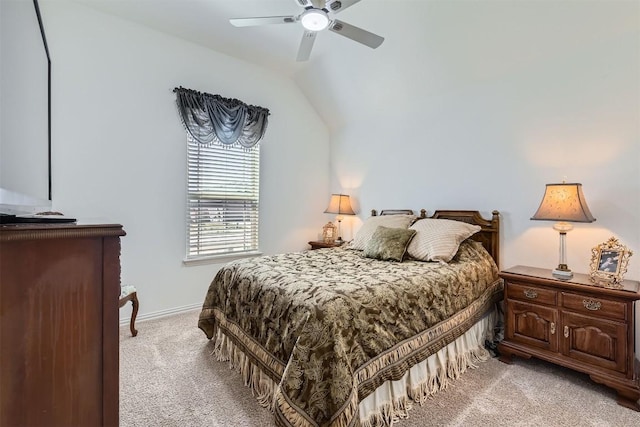 bedroom featuring light colored carpet, baseboards, a ceiling fan, and vaulted ceiling
