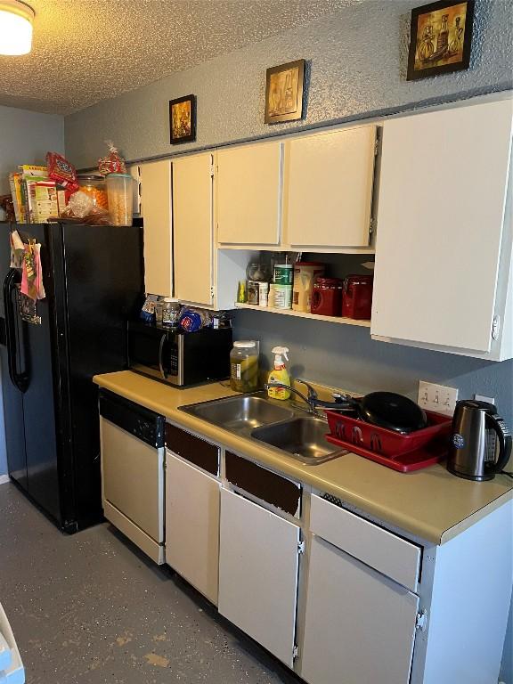 905 Fieldwood Dr, Austin, TX 78758 - kitchen featuring stainless steel microwave, dishwasher, open shelves, light countertops, and a textured ceiling