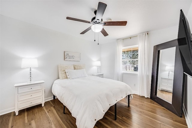 618 Bentwood Dr, Leander, TX 78641 - bedroom with baseboards, wood finished floors, and ceiling fan