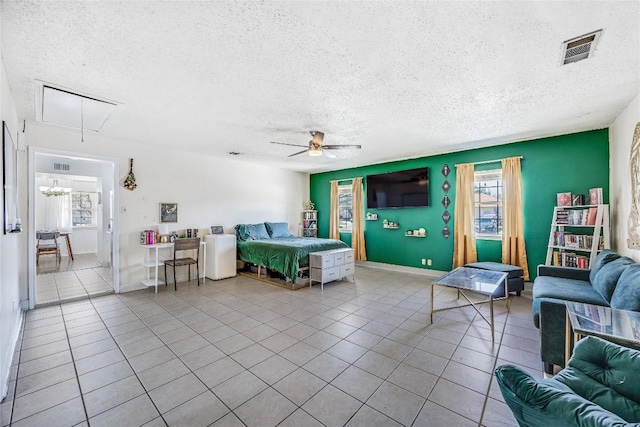 618 Bentwood Dr, Leander, TX 78641 - bedroom with attic access, visible vents, tile patterned flooring, and a textured ceiling
