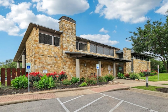 view of property featuring uncovered parking and fence