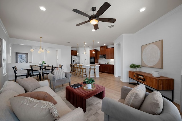 living room with recessed lighting, visible vents, light wood-style flooring, and ceiling fan