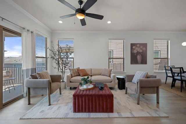 living area with crown molding, baseboards, recessed lighting, wood finished floors, and a ceiling fan