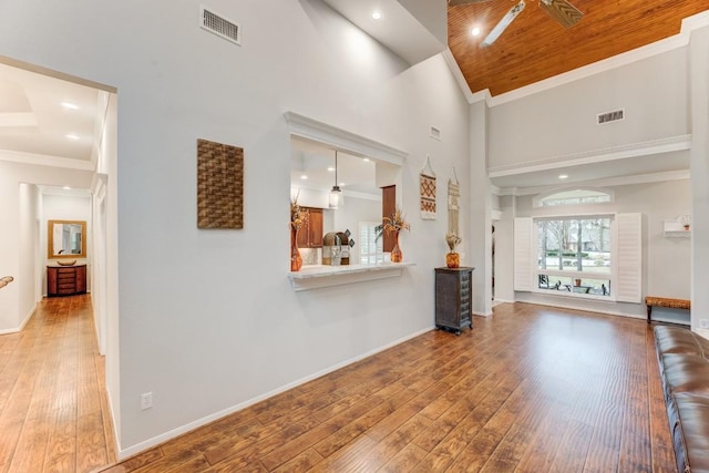 14904 Oak Shores Dr, Willis, TX 77318 - unfurnished living room with wood-type flooring, a towering ceiling, baseboards, ornamental molding, and recessed lighting