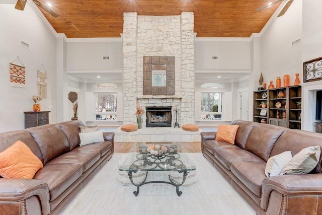 14904 Oak Shores Dr, Willis, TX 77318 - living room featuring wood ceiling, crown molding, a stone fireplace, a high ceiling, and wood finished floors