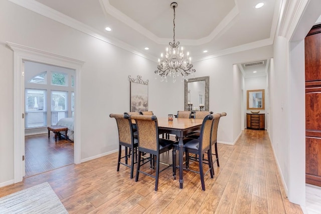 14904 Oak Shores Dr, Willis, TX 77318 - dining area with a chandelier, light wood-style flooring, a tray ceiling, ornamental molding, and recessed lighting