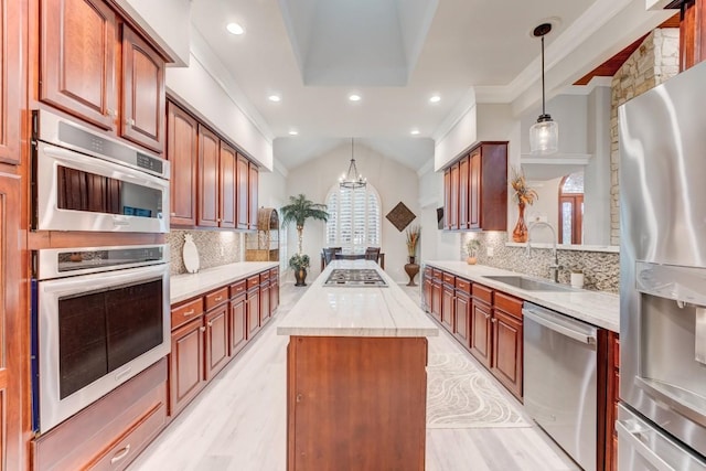 14904 Oak Shores Dr, Willis, TX 77318 - kitchen featuring stainless steel appliances, a sink, a center island, plenty of natural light, and lofted ceiling