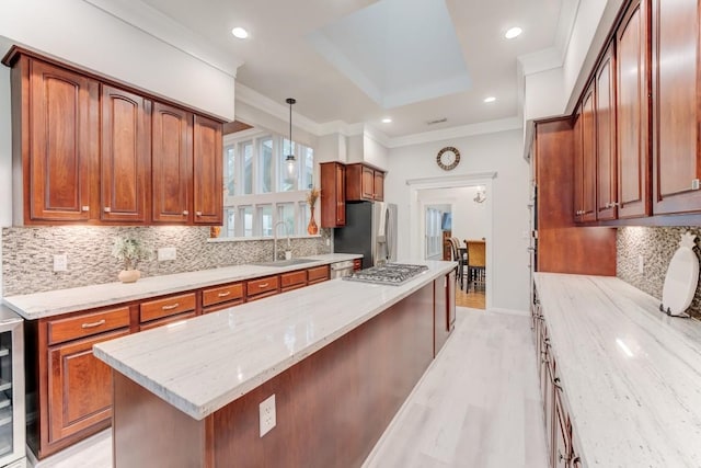 14904 Oak Shores Dr, Willis, TX 77318 - kitchen featuring a sink, light wood-style floors, light stone countertops, appliances with stainless steel finishes, and backsplash
