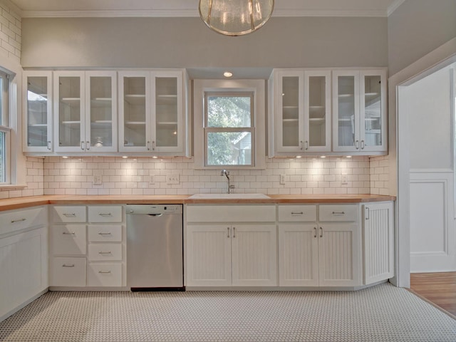 1203 W 22 1/2 St, Austin, TX 78705 - kitchen with wooden counters, stainless steel dishwasher, a sink, crown molding, and backsplash